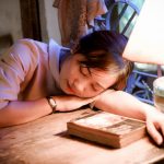 woman sleeping with her head on the table